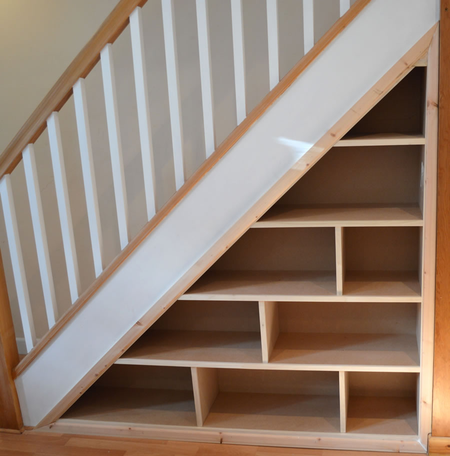 Understairs bespoke bookcase and fitted shelving